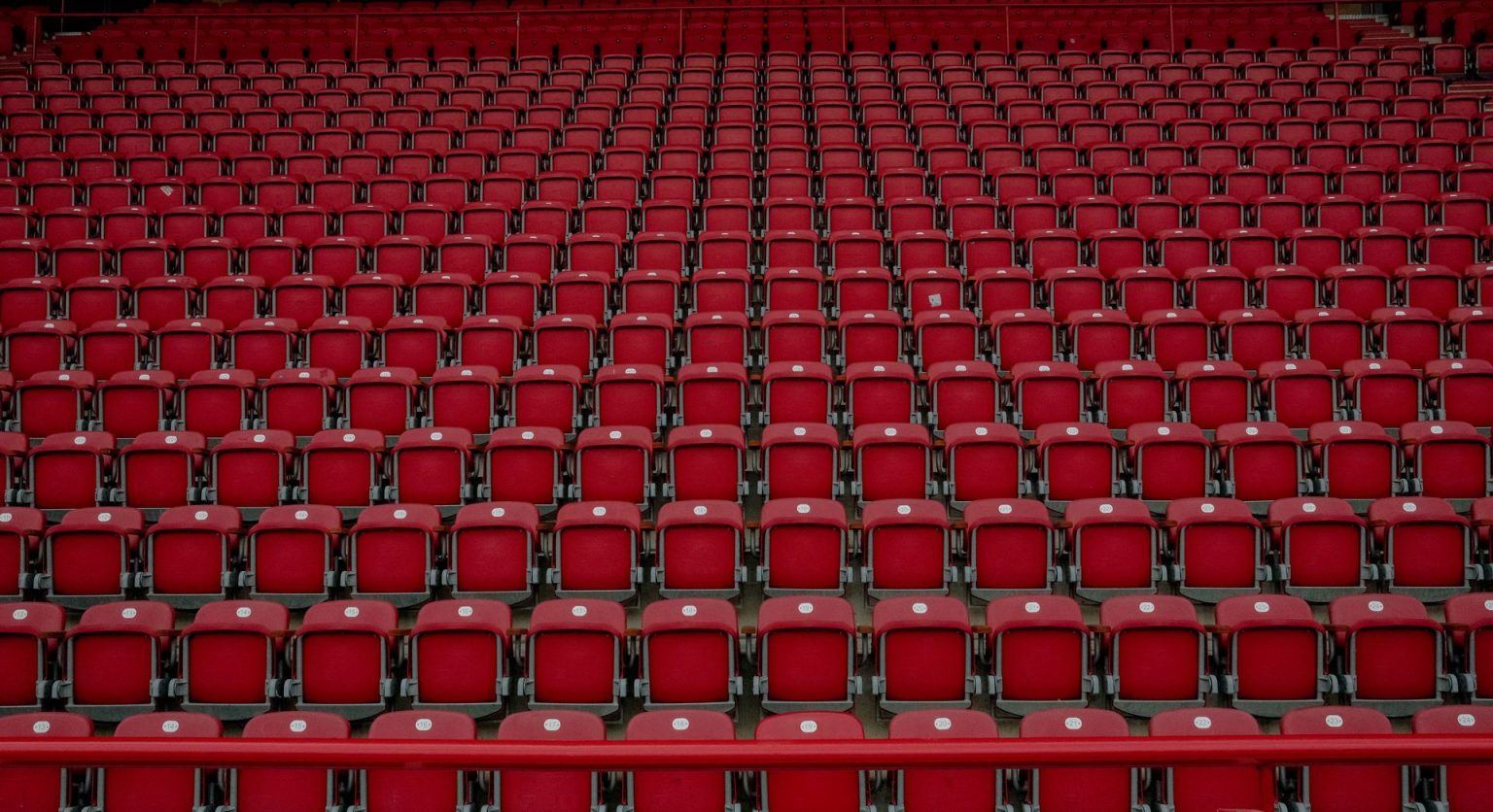 How international breaks affect the Premier League and European football season Rows of empty red seats in a football stadium