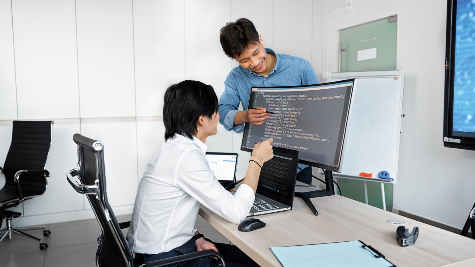 Engineers reviewing code on a monitor: Product Teams Should Run These Checks Before Integrating a Public-Record API