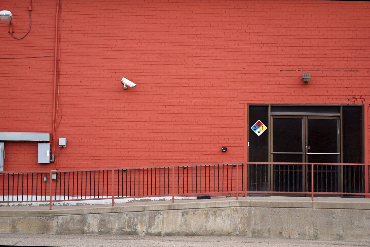 UK Firms Face a Near One-in-Three Chance of Suffering Crime This Year Security camera and rear entrance on a commercial building: UK Firms Face a Near One-in-Three Chance of Suffering Crime This Year