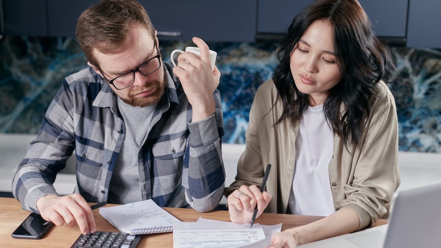 Households Urged to Avoid Knee-Jerk Moves Ahead of the Autumn Budget Households Urged to Avoid Knee-Jerk Moves Ahead of the Autumn Budget: a couple reviewing household bills with a calculator before the Budget
