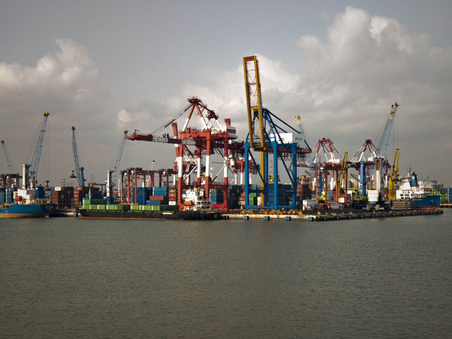 The $1 Trillion Infrastructure Project That Could Rewire the Global Economy — and Nobody Outside of Beijing Knows the Full Details Container cranes and cargo ships at a busy port in Jakarta, Indonesia