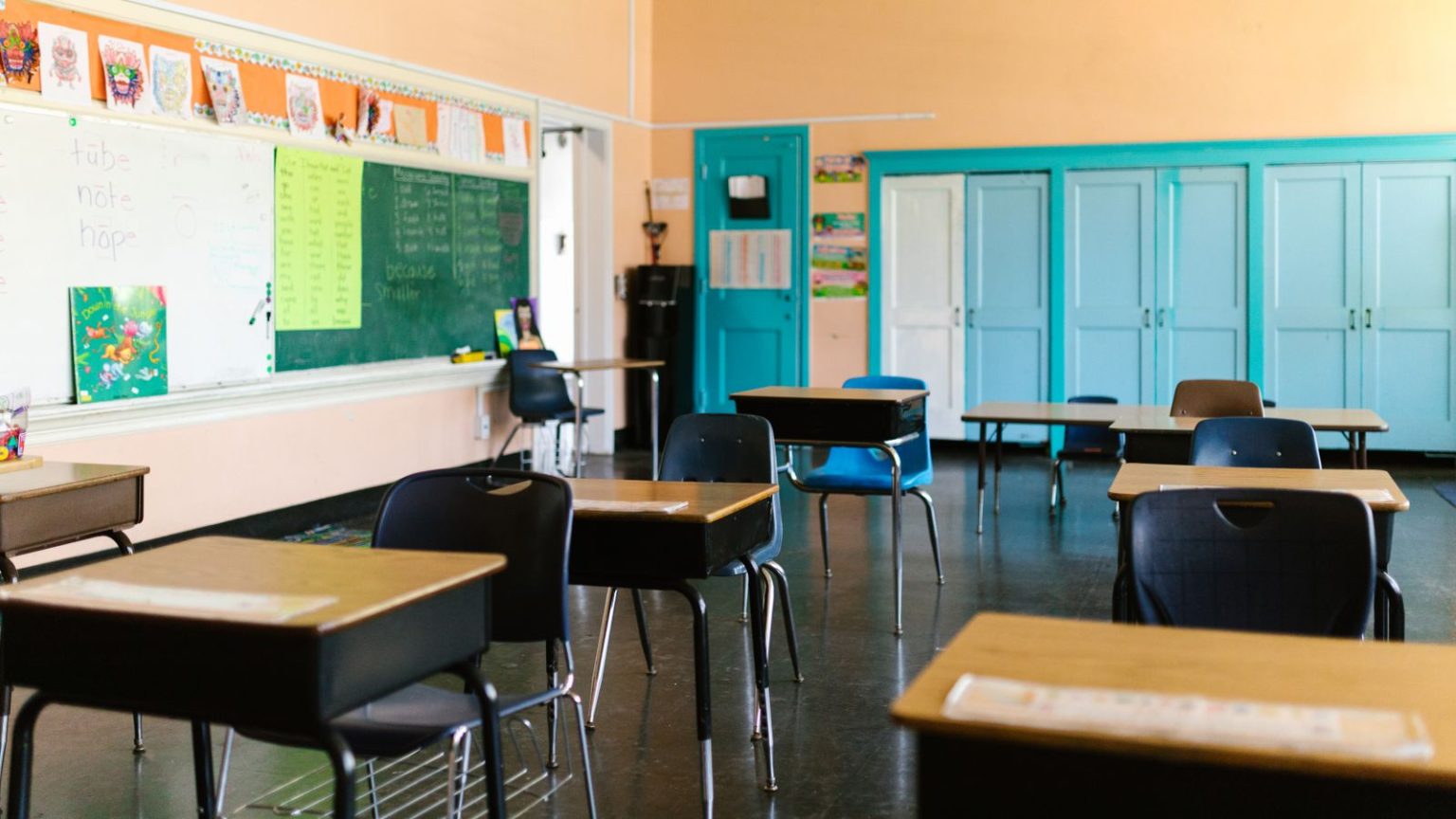 Manchester study says primary homework may favour families with more time and money Empty desks and chairs in a primary school classroom