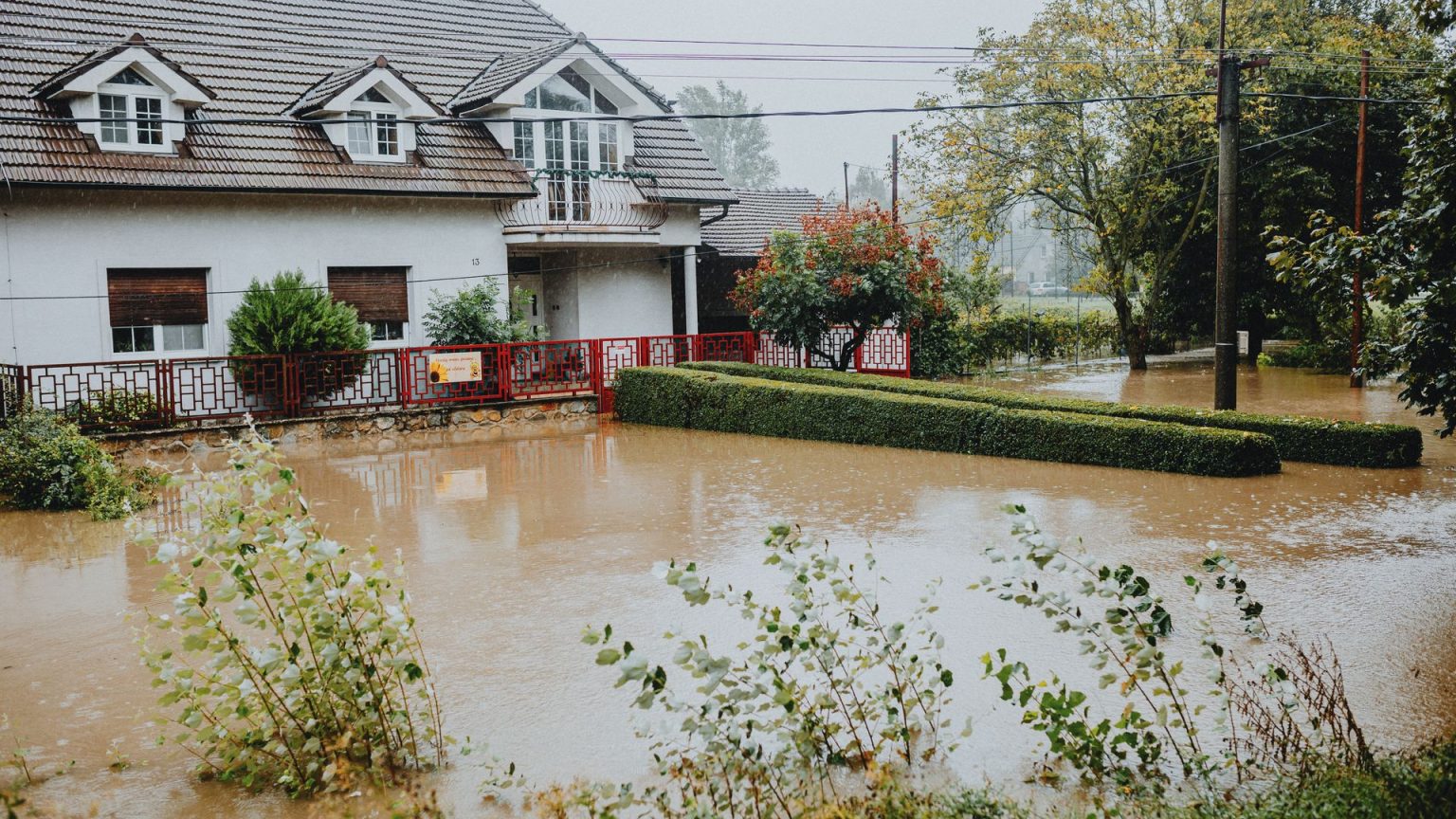 Floodwater surrounding a detached house after heavy rain
